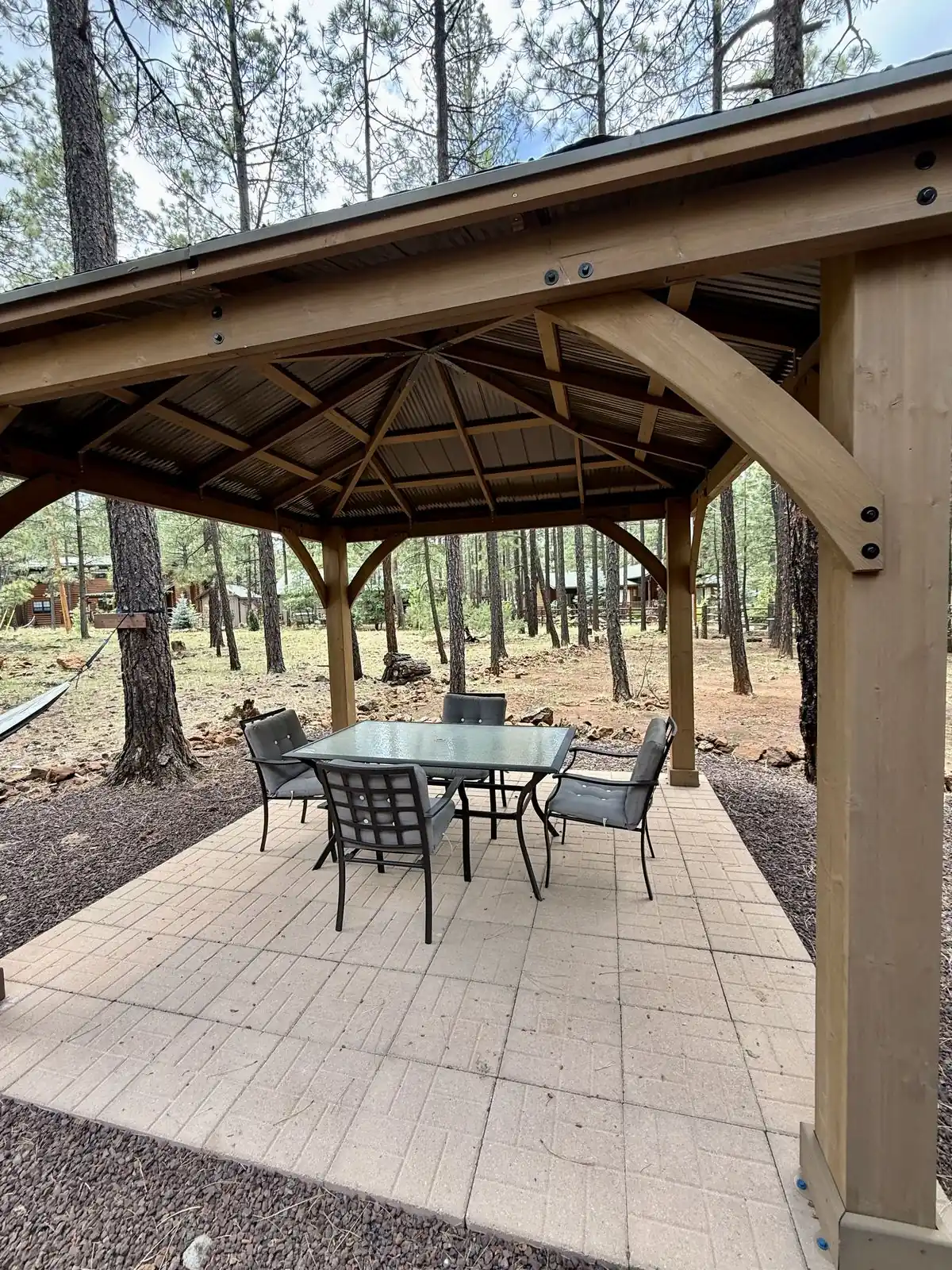 Covered pergola with patio table and chairs