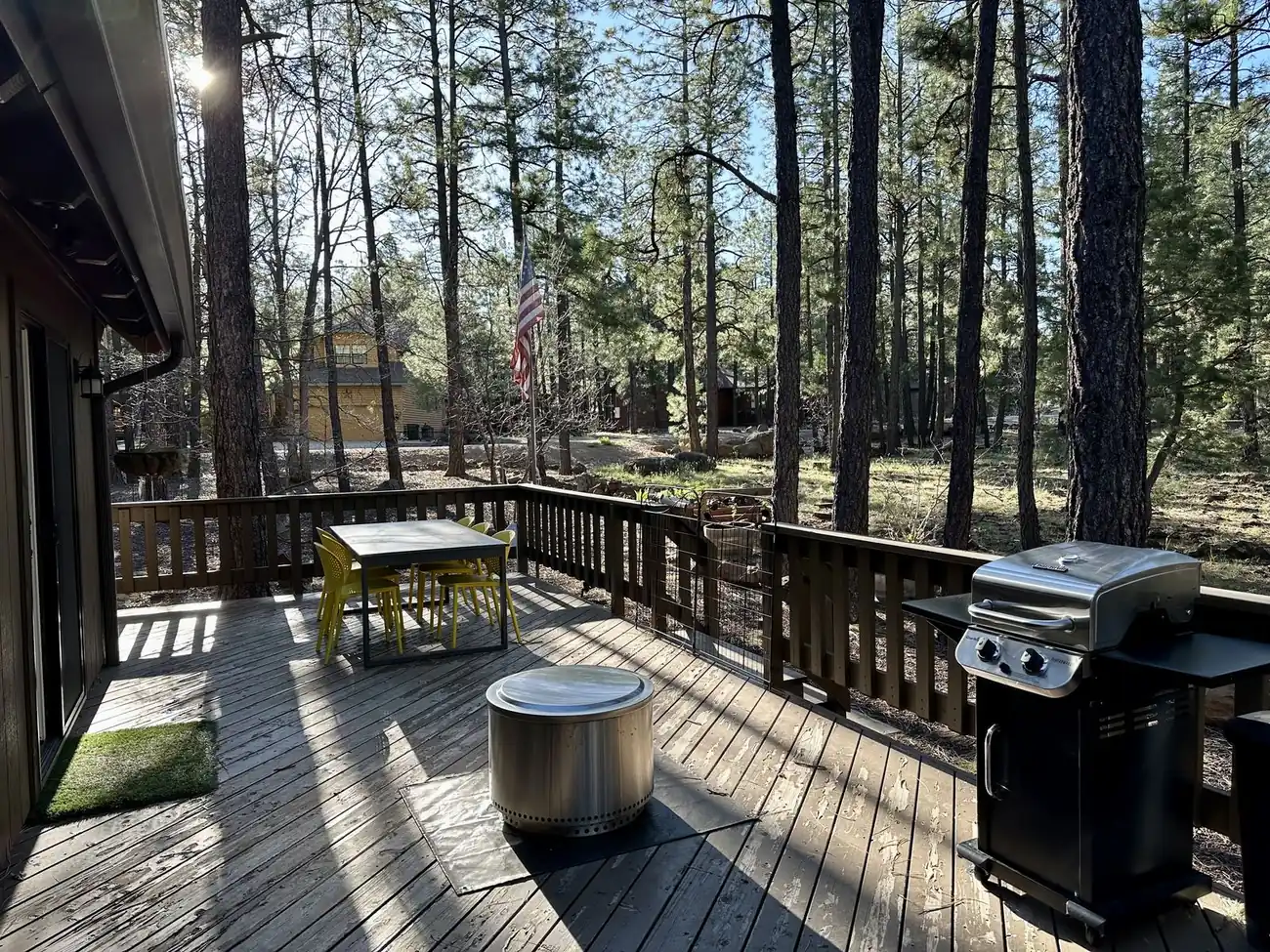 Deck with gas grill, dining table, and fire pit