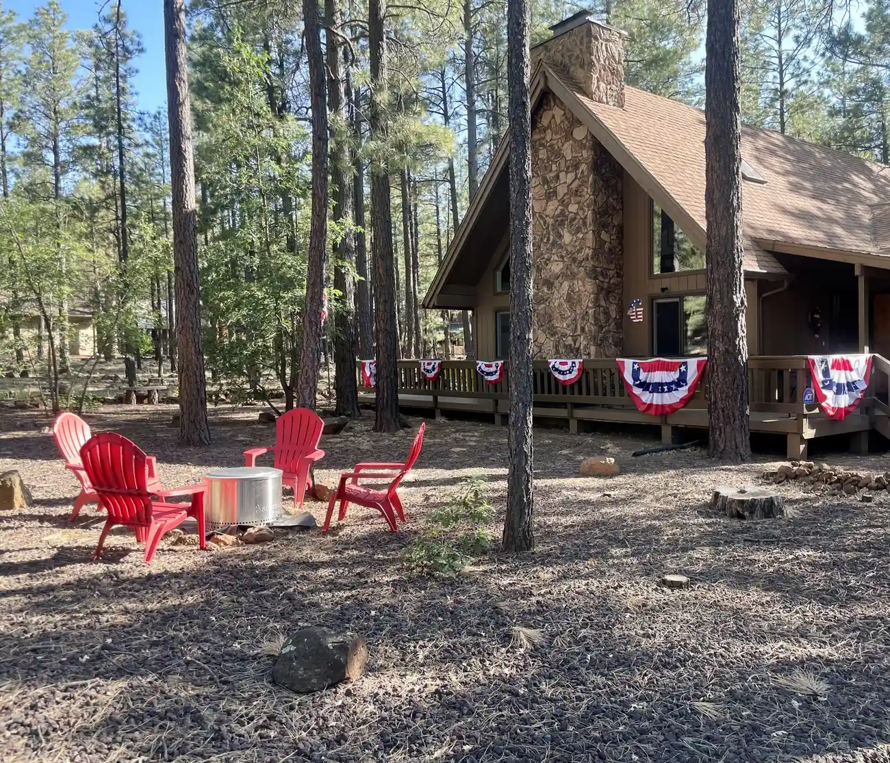 Fire pit with red Adirondack chairs