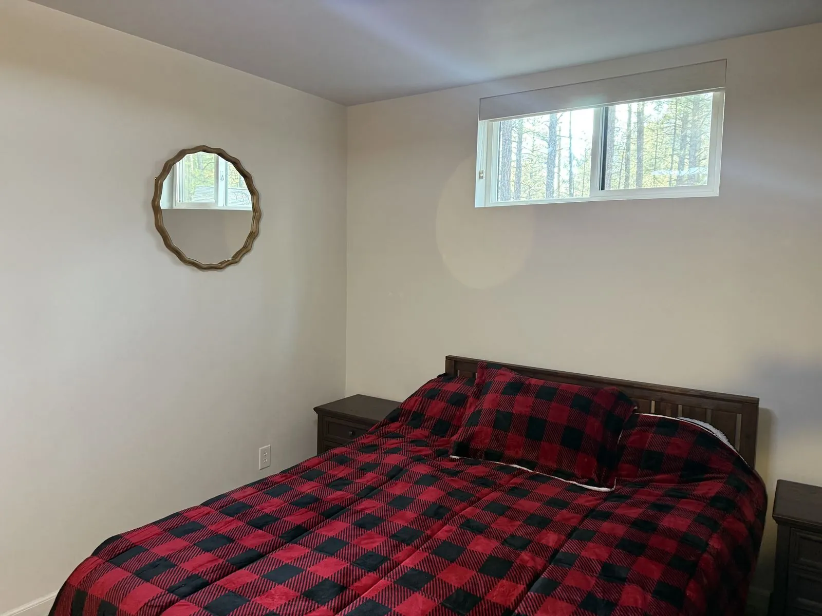 Guest bedroom bed with round mirror