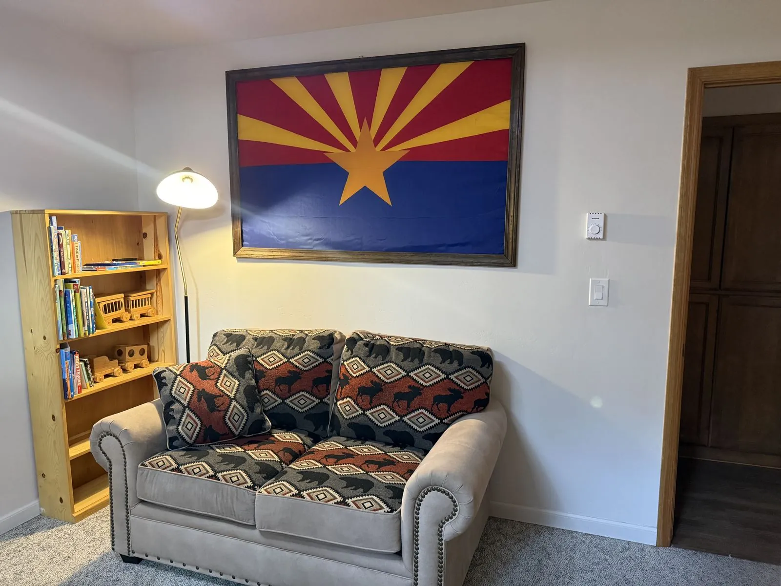 Guest bedroom sitting nook with bookshelf