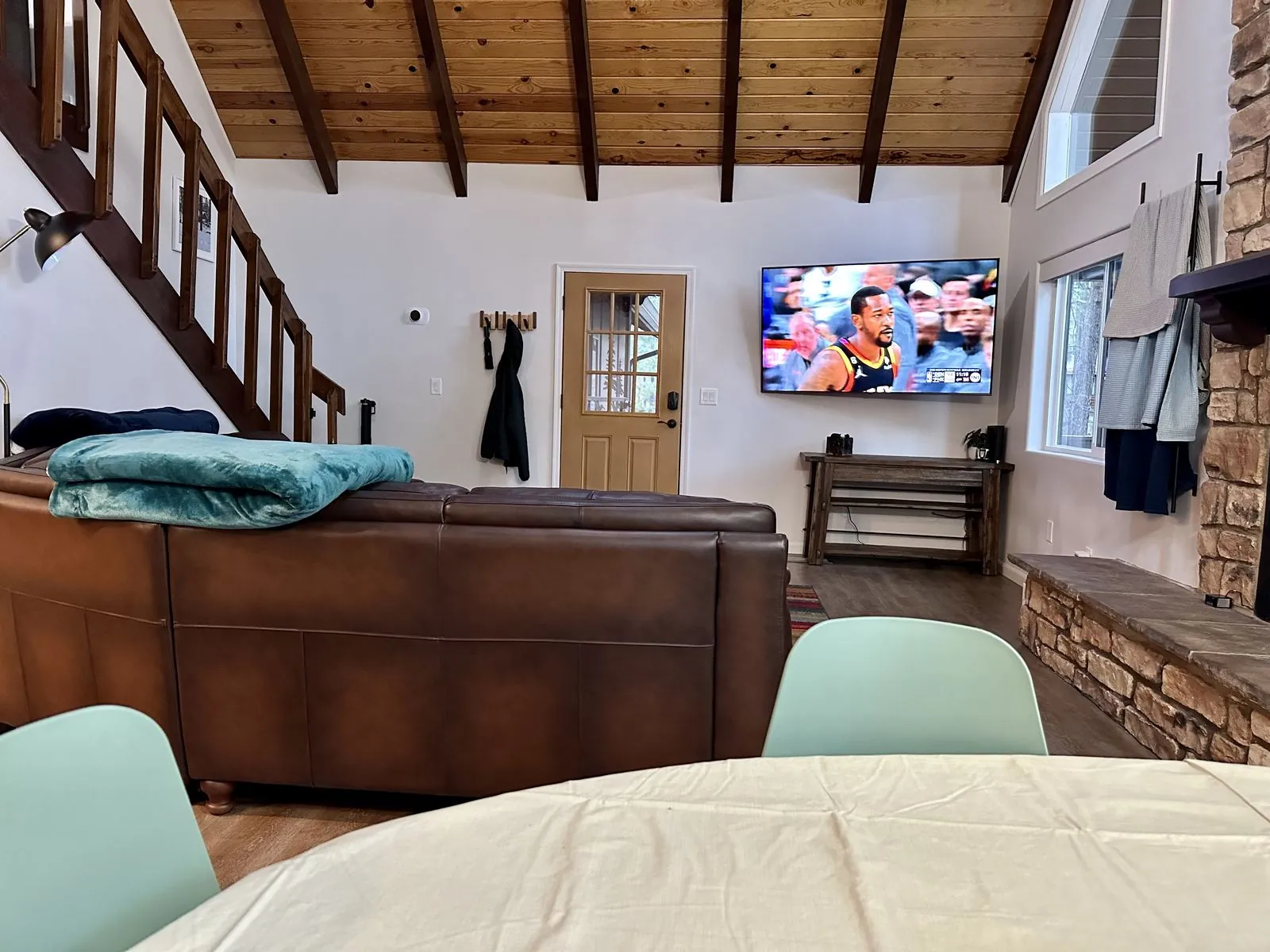 Living room with leather sofa and mounted TV