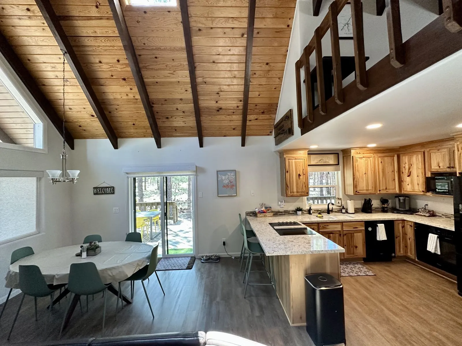 Open kitchen, dining area, and loft above