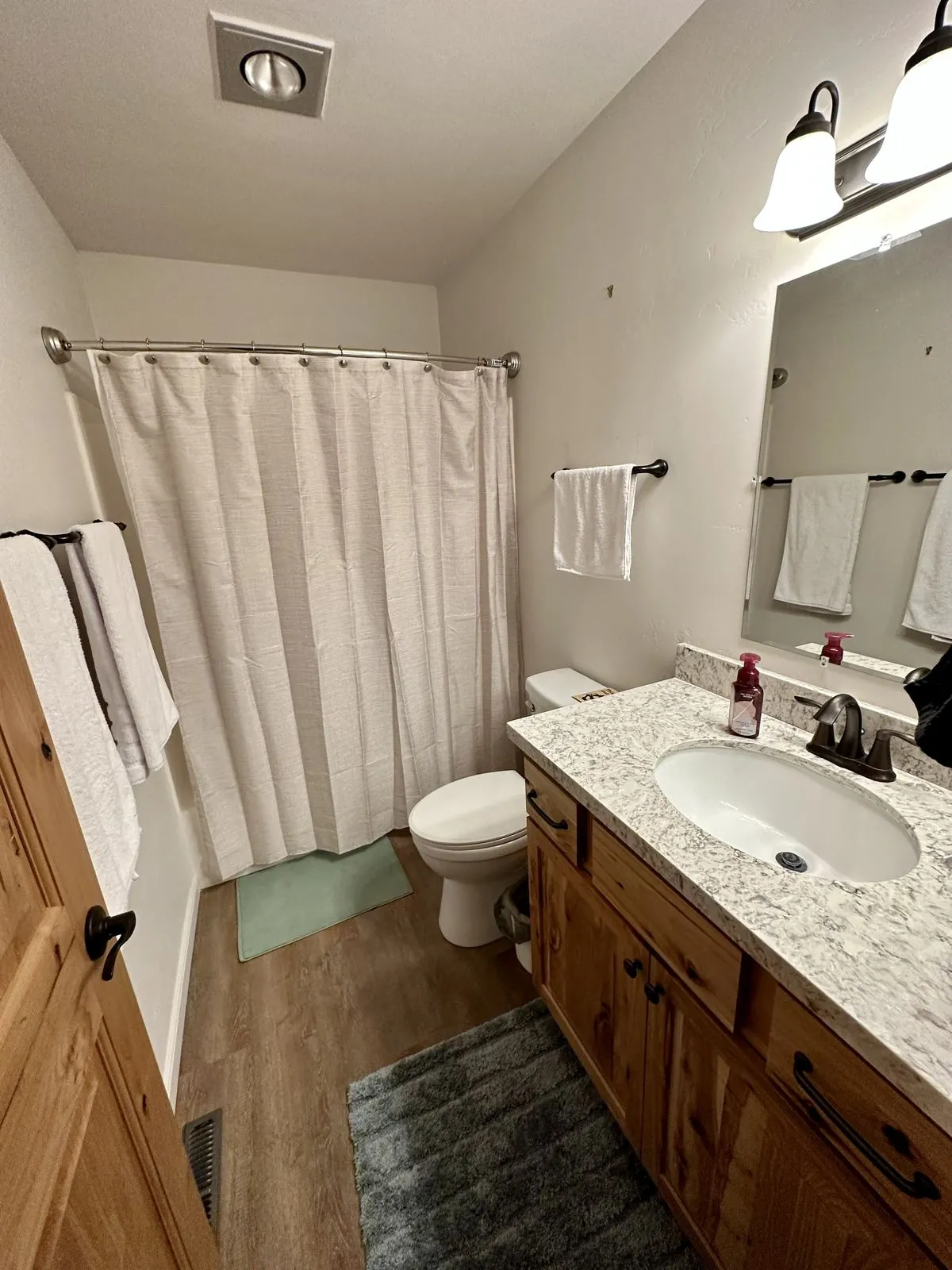 Primary bathroom vanity with granite counter