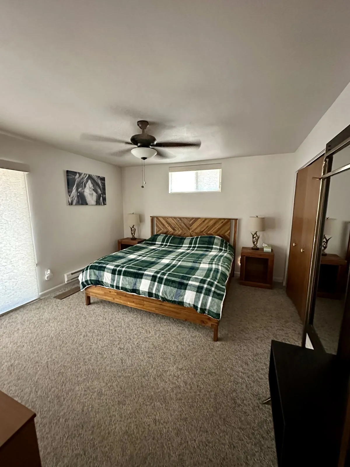 Primary bedroom wide view with wood plank headboard