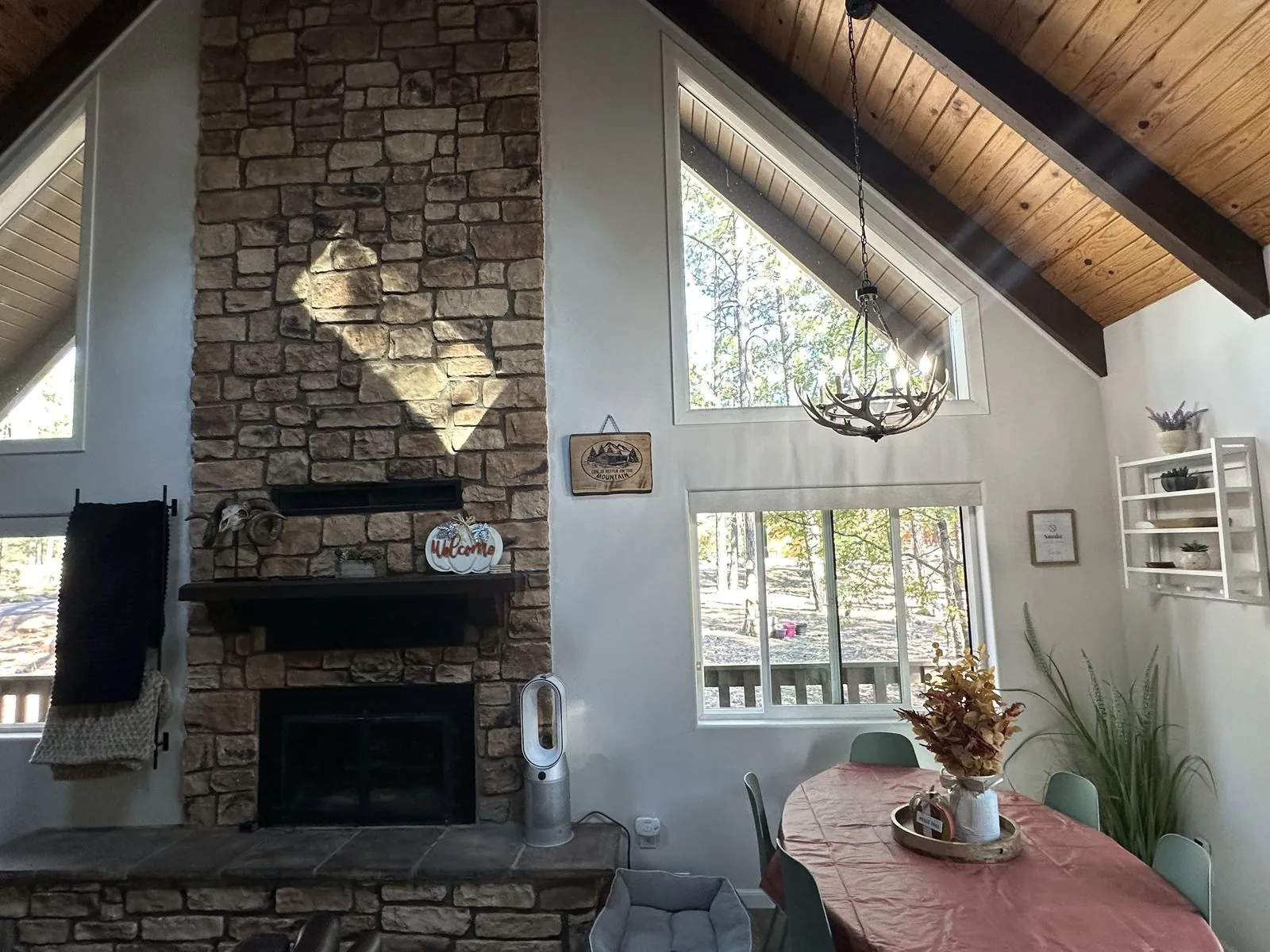Stone fireplace and dining table by day